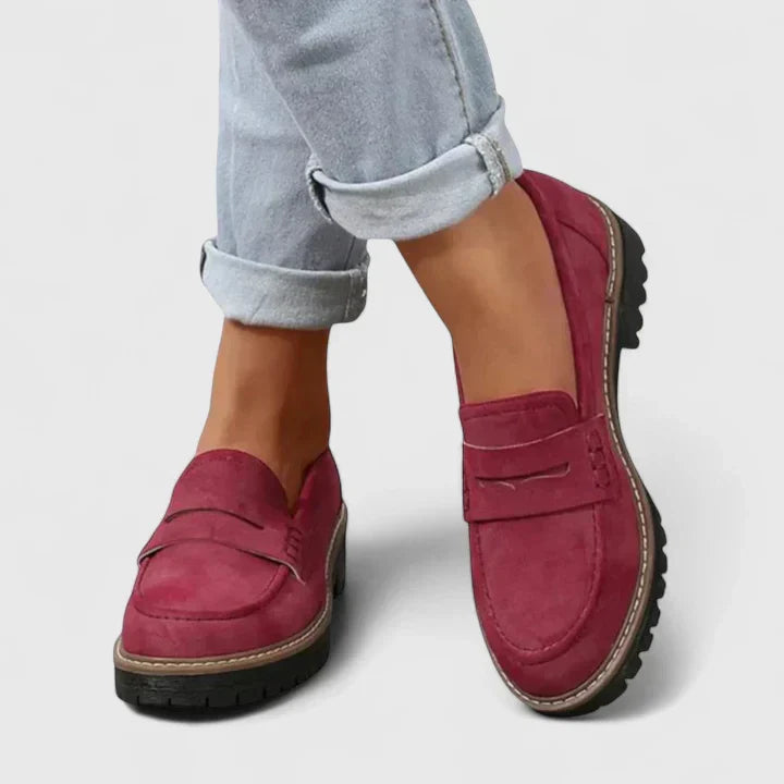 Slip-on women's chunky penny loafers with a distinct lug sole, great for a modern, preppy, casual look.