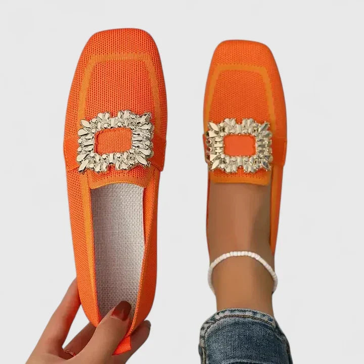 Close-up of sparkling rhinestone buckle on women's stylish square toe slip-on mules. Dressy flat mules.