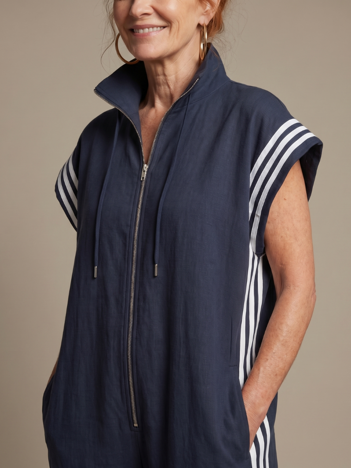 Women's full length zip front jumpsuit. High neck, cap sleeve, and distinctive sporty side stripe panels.