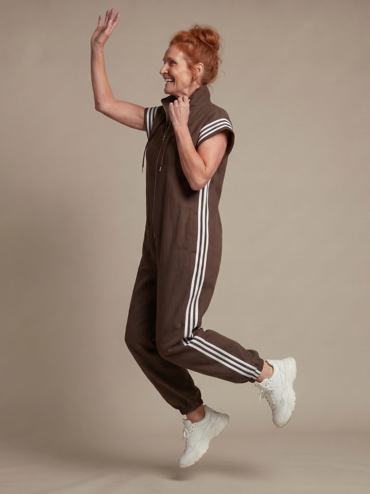 Comfortable women's jumpsuit, perfect for summer. Zip front, high neck, and sporty side stripe accents.