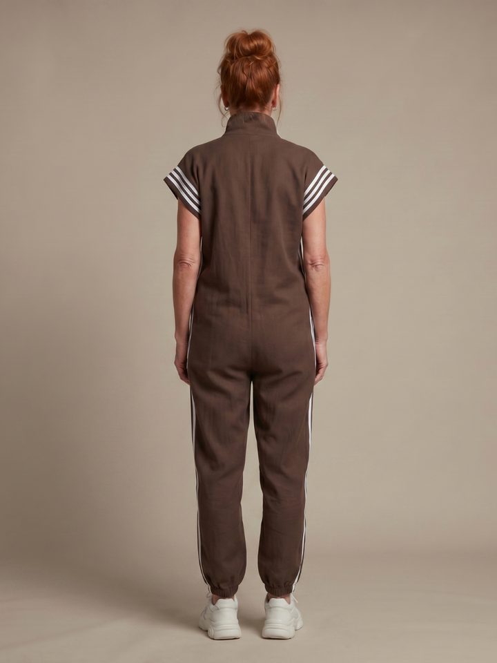 Women's black zip front jumpsuit, full length, with a high neck and athletic-inspired side stripe detail.