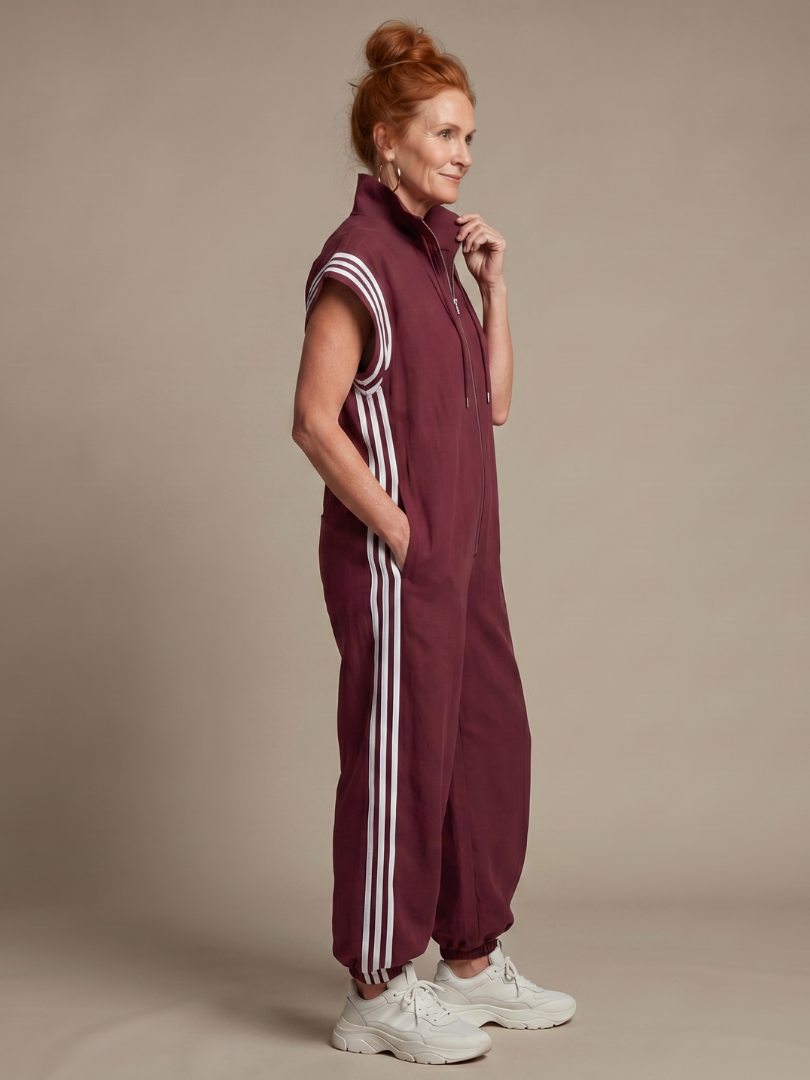 Effortless women's zip front jumpsuit, cap sleeve, full length. Sporty chic with side stripe detail, comfortable.