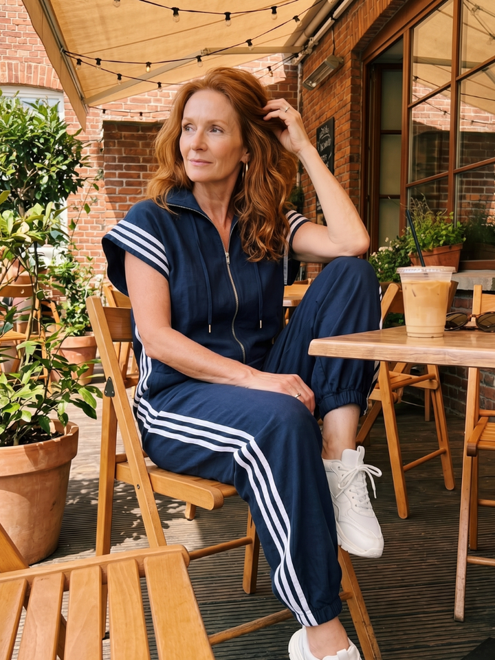 Casual women's high neck jumpsuit, zip front, relaxed fit. Full length with contrasting sporty side stripes.