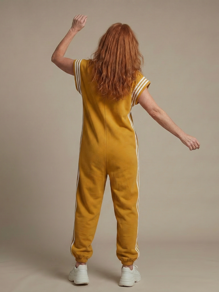 Relaxed fit women's casual jumpsuit with a high neck, zip front, and stylish sporty side stripes. Summer outfit.