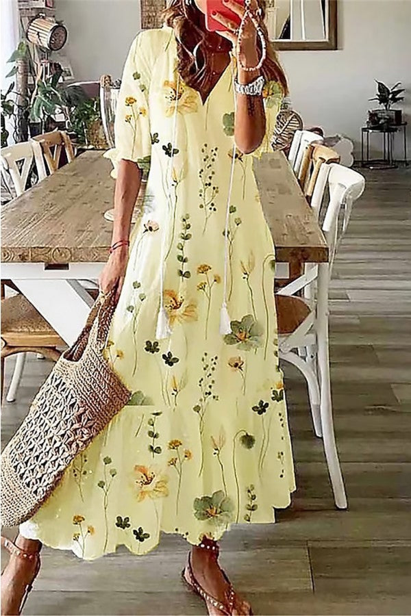 Stylish women's floral boho maxi dress with V-neckline & playful tassels, great for a relaxed summer or resort look.