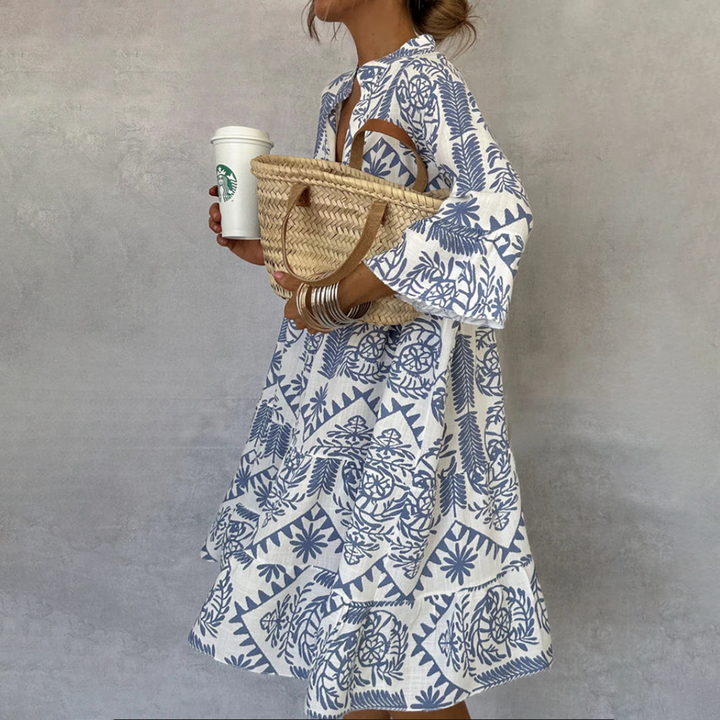 Women's boho print swing dress with flowing V-neck & 3/4 sleeves. Ideal for summer casual or resort fashion.