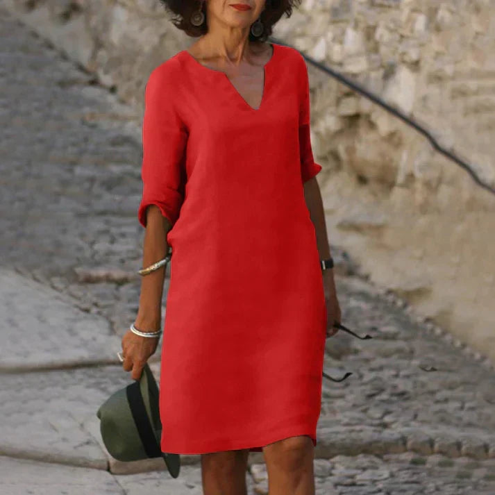 Breezy & flowy women's V-neck midi dress. Short-sleeve design offers comfortable, elegant style for summer days.