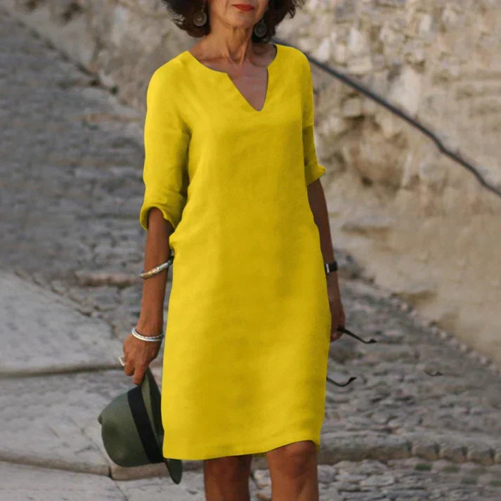 Comfortable breezy midi dress for women, with a chic V-neck & short sleeves. Perfect flowy summer vacation wear.