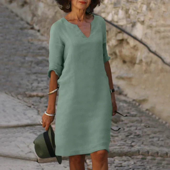 Simple yet elegant women's V-neck midi dress. Breezy, short-sleeve design for comfortable summer and day wear.