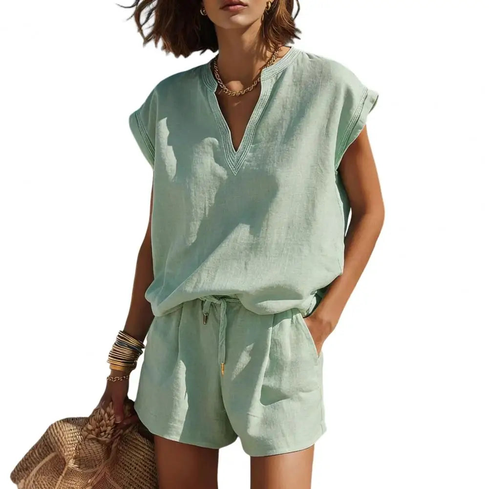 Close-up of a woman wearing a casual linen V-neck top from a summer co-ord set with stylish notch.