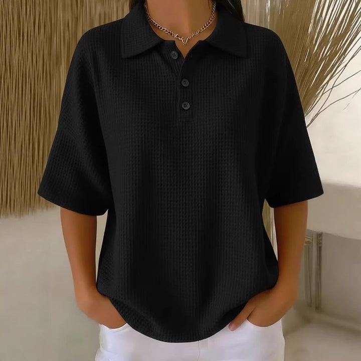 Relaxed women's polo neck blouse, short sleeve, loose fit for versatile casual wear.