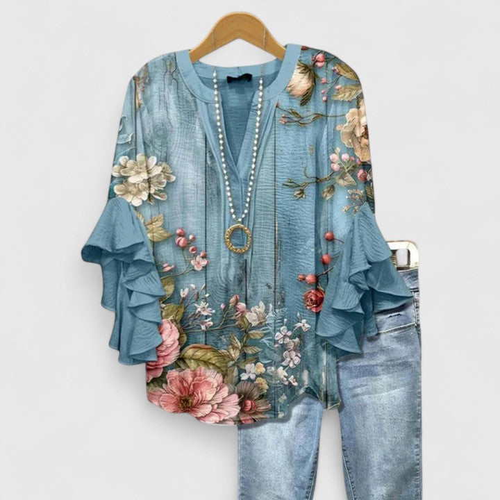 Chic floral print women's blouse with elegant ruffled sleeves, a versatile style for women.