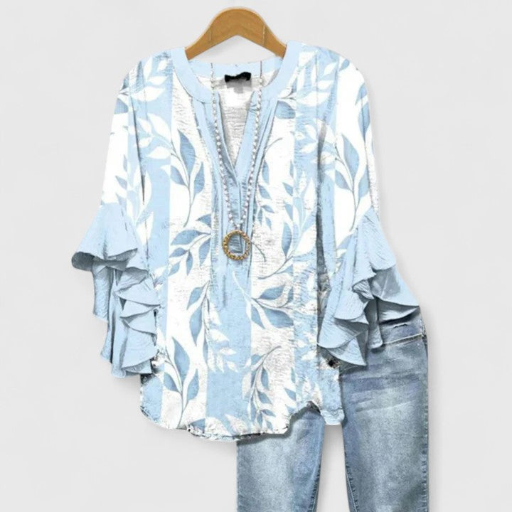 Casual chic women's floral blouse with playful ruffled sleeves, great for a breezy summer day.