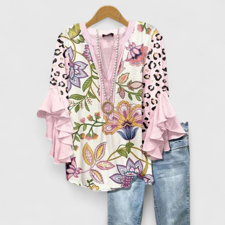 Stylish women's blouse featuring a beautiful floral pattern and trendy ruffled sleeves.