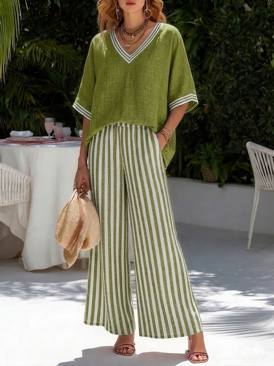 Model wearing a comfortable women's striped two-piece set with v-neck top & wide-leg pants.