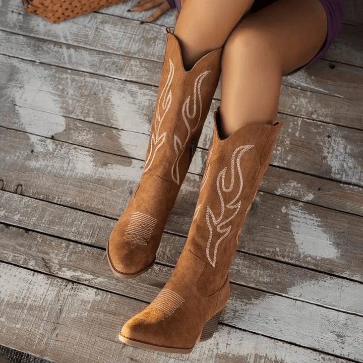Boho-chic women's cowboy boots. Features a classic embroidered design, pointed toe, block heel & side zipper.