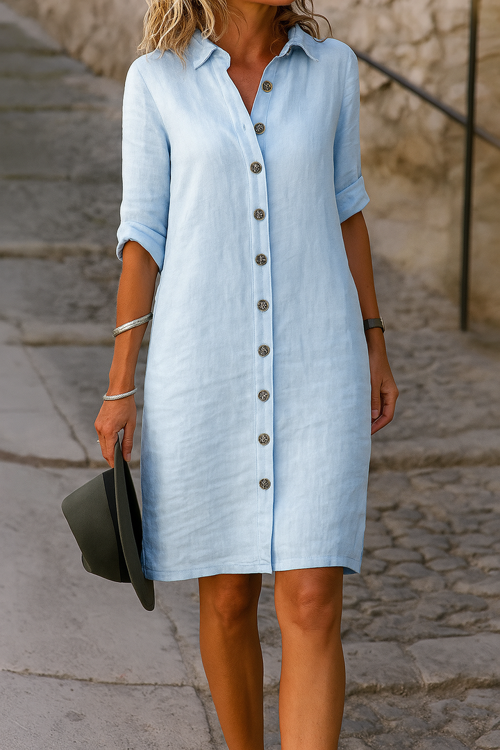 Women's button-front shirt dress with roll-tab sleeves; chic, comfortable for vacation or casual.