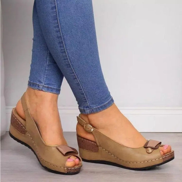 Stylish peep toe slingback wedge sandals for women. Features a low wedge heel for all-day comfort.
