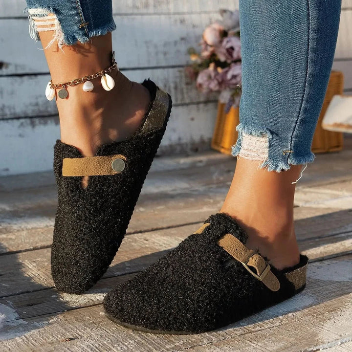 Comfortable women's winter mules with anti-slip sole, warm and soft slip-on footwear for cozy lounging.
