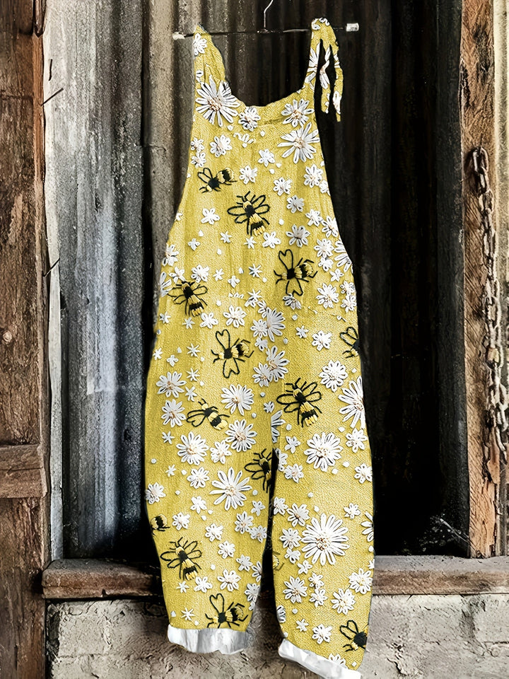 Front view: Women's casual daisy bee print tie shoulder wide leg jumpsuit.