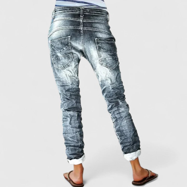 Trendy women's blue distressed wide leg jeans, relaxed fit mid-rise pants, perfect for fashion.