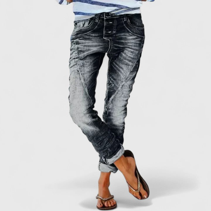 Stylish black women's distressed wide leg jeans with frayed hems & ripped details, casual fashion.