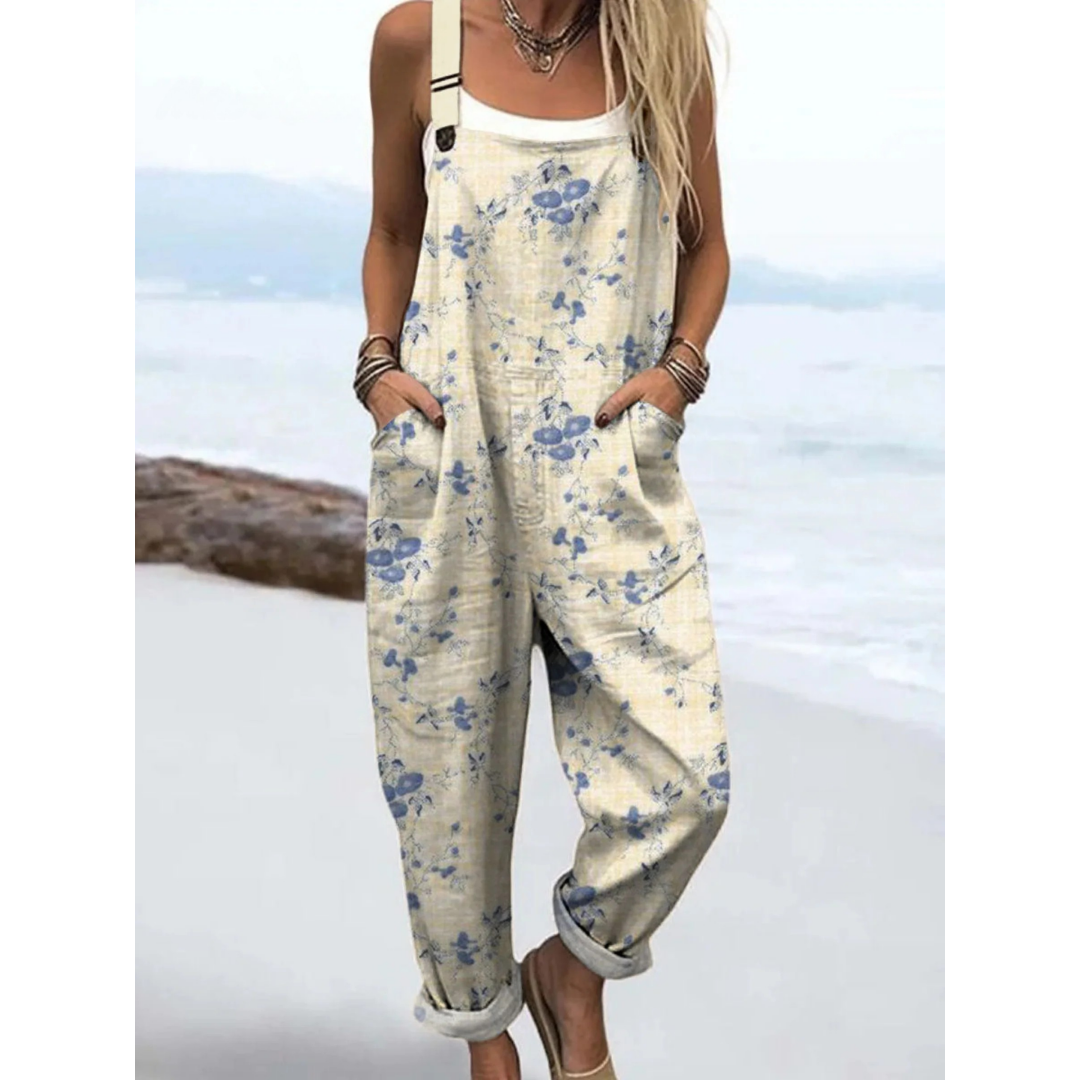 Women's ditsy floral boho jumpsuit with adjustable straps, ideal for summer casual wear or beach days. Relaxed fit.