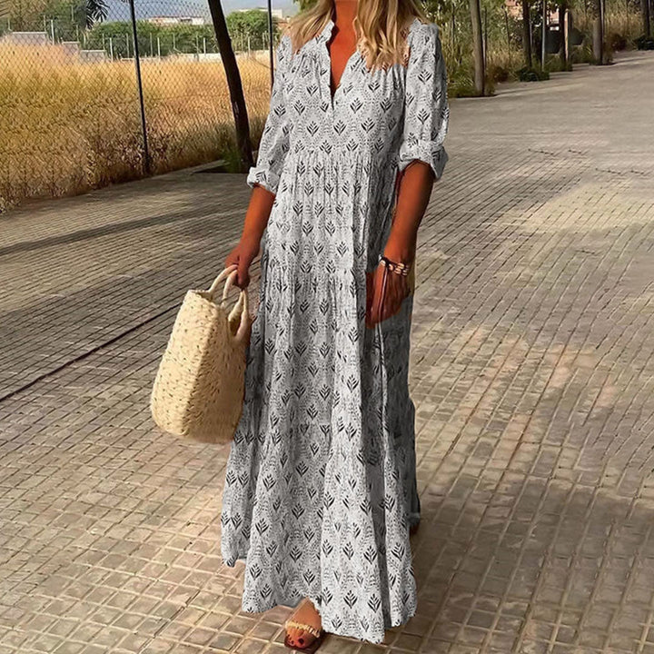 Woman wearing a flowing boho print V-neck maxi dress, ideal for summer festivals, beach, or relaxed casual look.