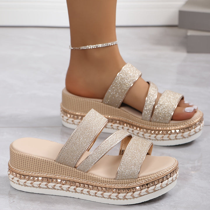 Slip-on women's flat sandals with open-toe design, offering all-day comfort. Perfect for casual summer wear.
