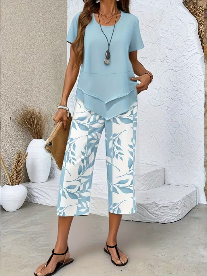 Stylish women's botanical leaf print short sleeve top & matching cropped pants. Relaxed fit two-piece set for comfort.