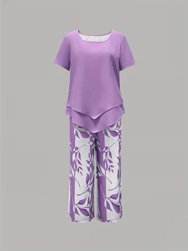 Woman sitting comfortably in a botanical leaf print co-ord set: short-sleeve top & cropped pants for leisure.