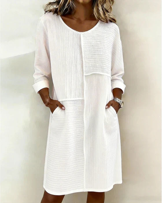 Women's effortless textured shift dress with three-quarter sleeves & pockets, perfect for casual spring & summer.