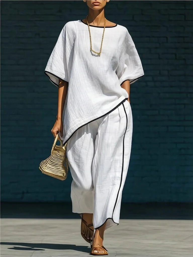 Versatile women's two-piece outfit: cropped pants & top. Ideal for casual, elegant, or travel wear. Relaxed fit.