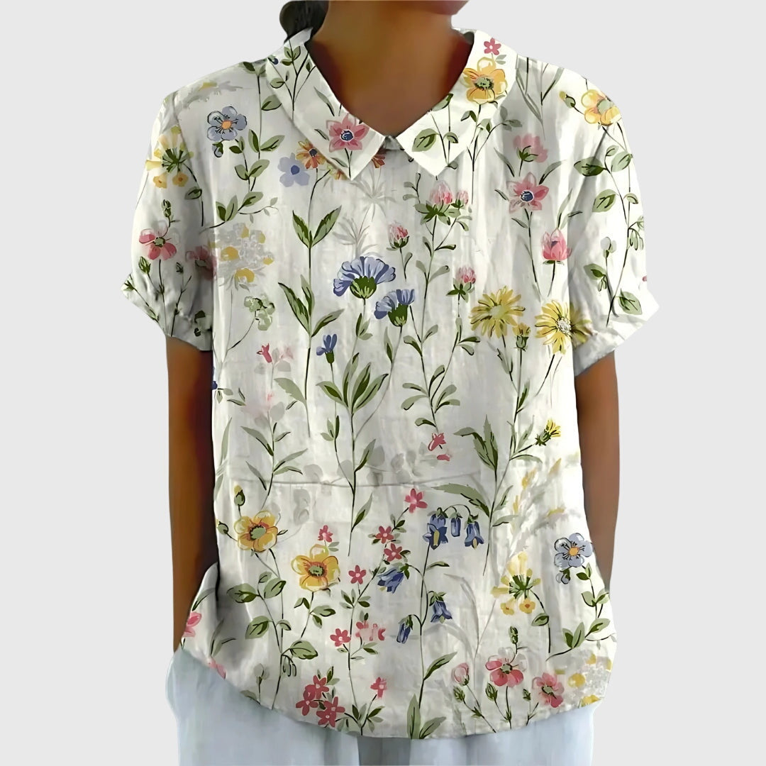 Elegant women's blouse featuring a vibrant floral print, suitable for casual everyday style.
