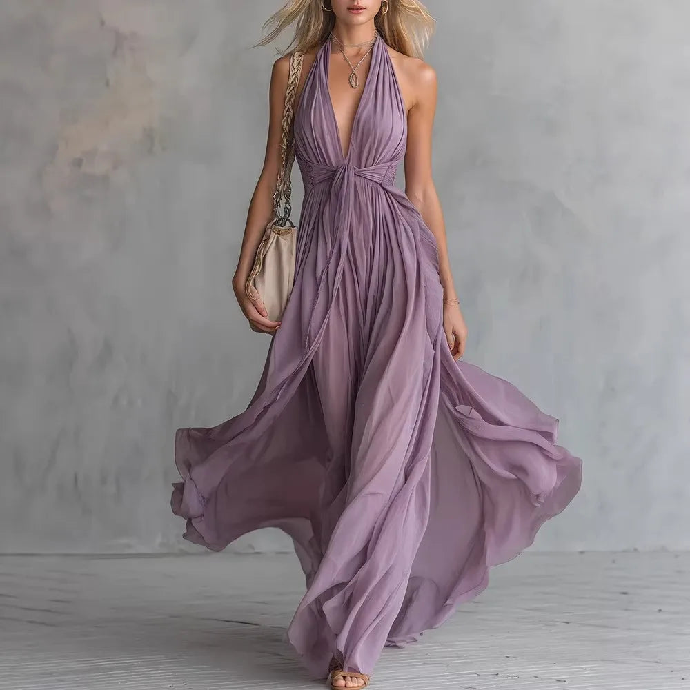 Women's elegant halter backless maxi dress with a flowing pleated skirt and stylish side slit.