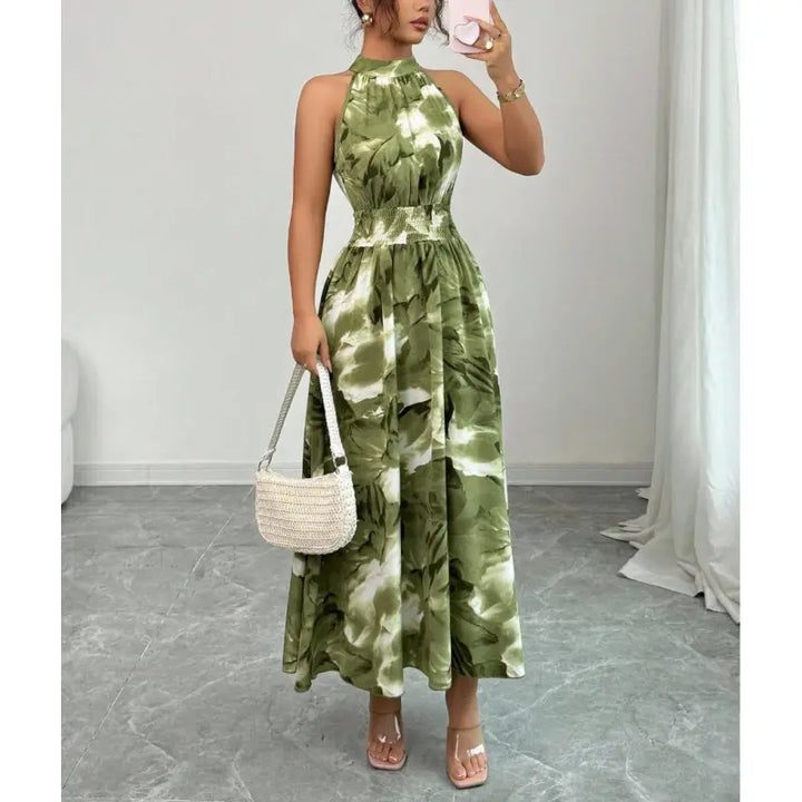 Women's elegant halter neck maxi dress with smocked waist & abstract print. Perfect sleeveless summer vacation dress.
