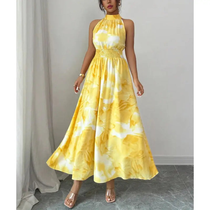 Summer halter neck maxi dress for women with a comfortable smocked waist and vibrant abstract print. Ideal for vacation.