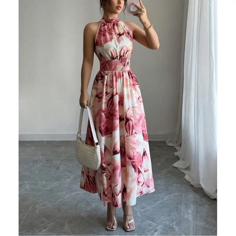 Sleeveless elegant women's halter neck maxi dress, featuring a flattering smocked waist and unique abstract print.