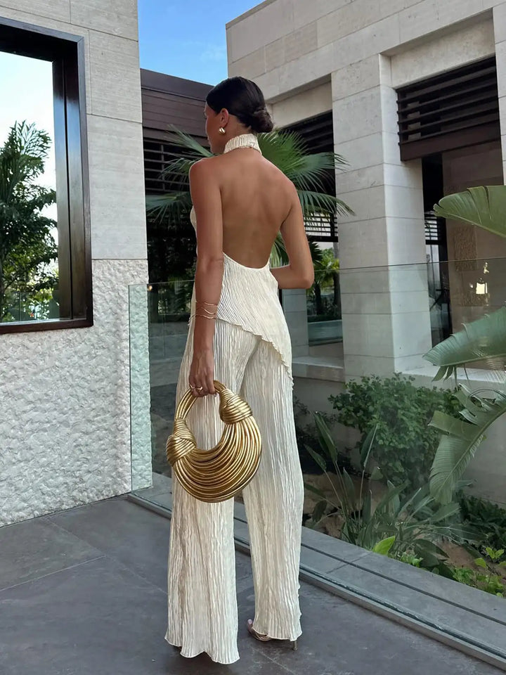 Trendy women's pleated wide-leg two-piece set featuring a chic halter top. Great for summer fashion.