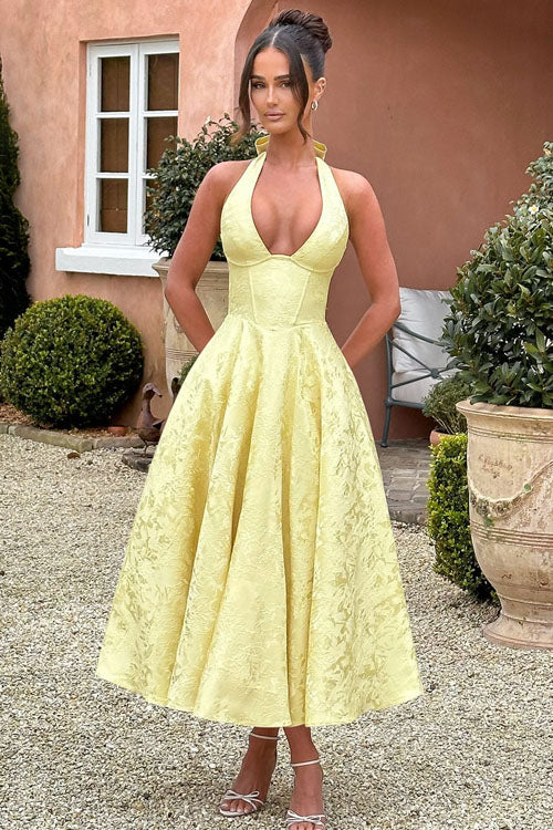 Delicate details of the halterneck on a women's elegant A-line maxi dress, perfect for formal evenings.