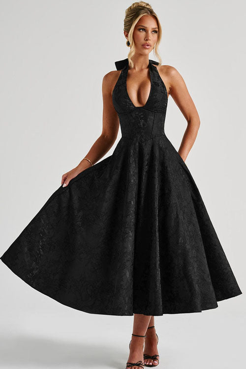 Full-length view of a women's elegant A-line maxi dress, with a stylish halterneck and long skirt.