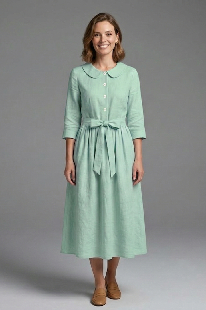 Women's flattering midi dress on hanger. V-neck, waist tie, perfect for versatile summer styling.