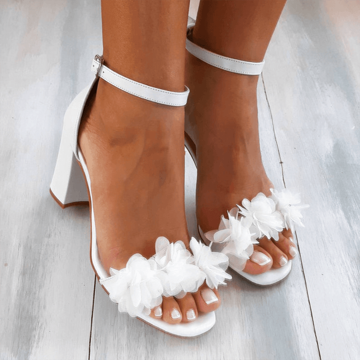 Women's elegant white block heel ankle strap sandals. Perfect for comfortable fashion and versatile dress wear.
