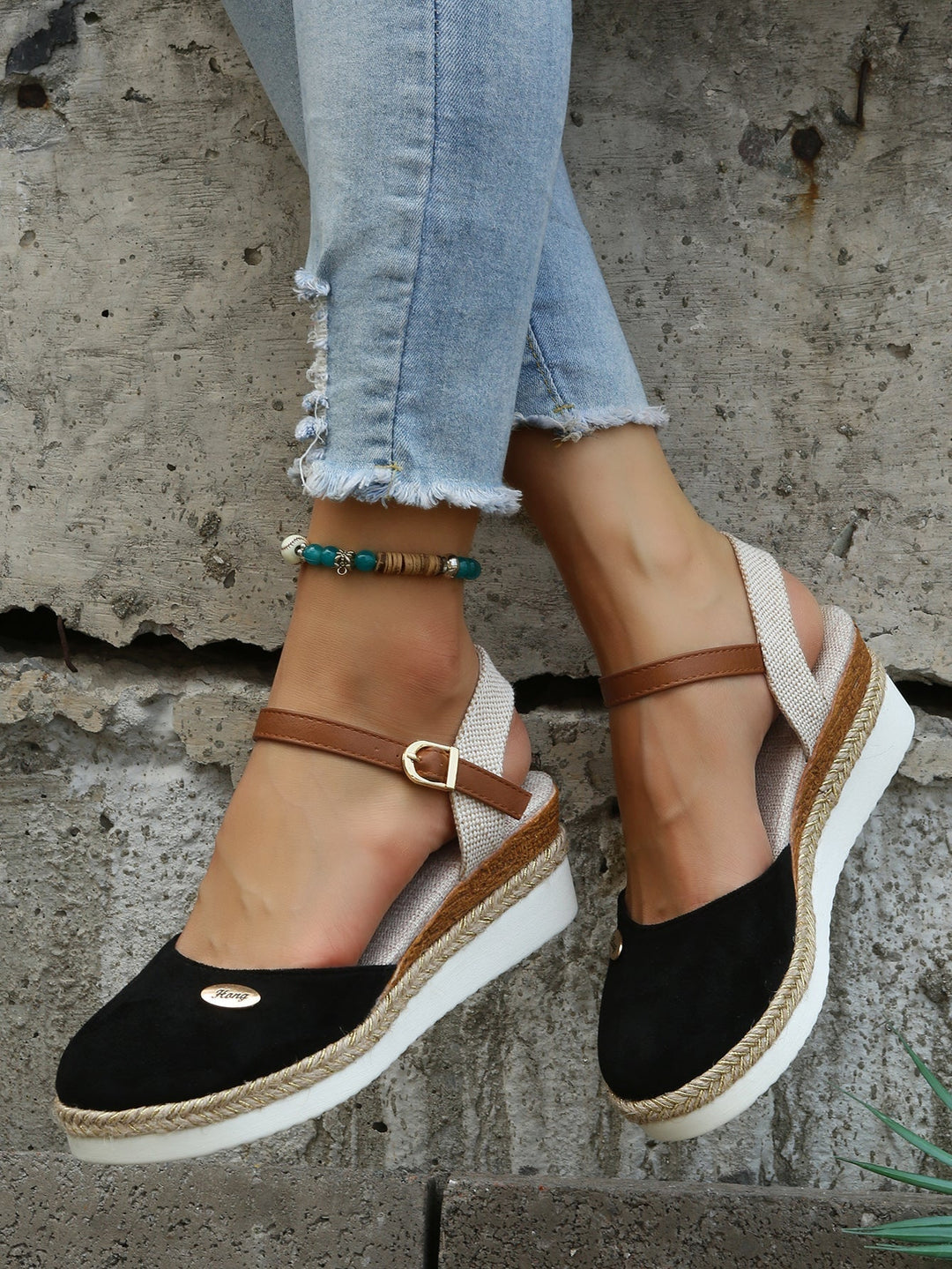 Close-up of women's comfortable woven sandals with cushioned sole. Stylish open-toe summer fashion footwear.