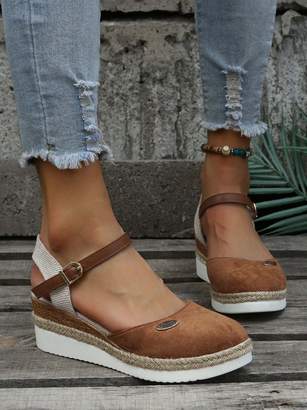 Full view of women's elegant woven sandals with comfortable cushioning. Stylish slip-on footwear for summer fashion.