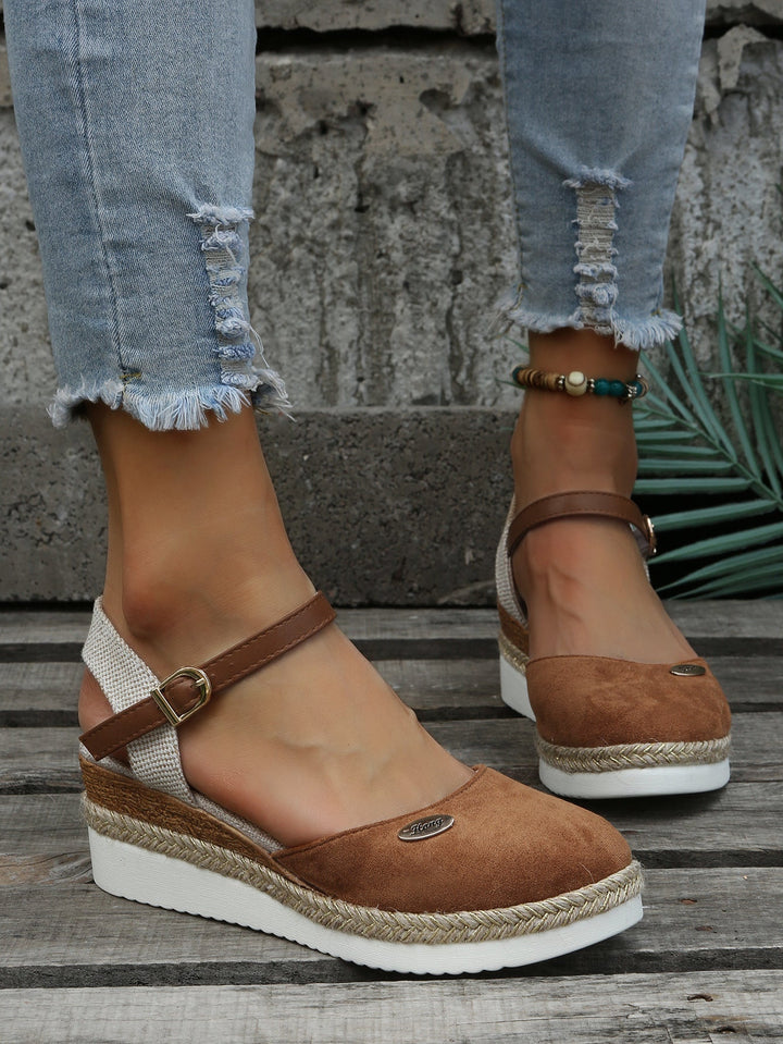Full view of women's elegant woven sandals with comfortable cushioning. Stylish slip-on footwear for summer fashion.