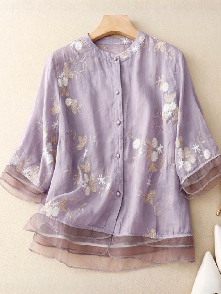 Elegant women's round neck blouse, intricate embroidery, long sleeves, button-front for spring.