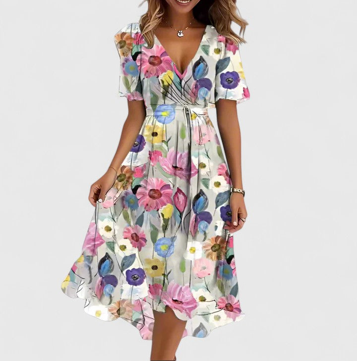 Comfortable women's floral flutter sleeve midi dress with a V-neck and high-low hem, offering versatile summer style.