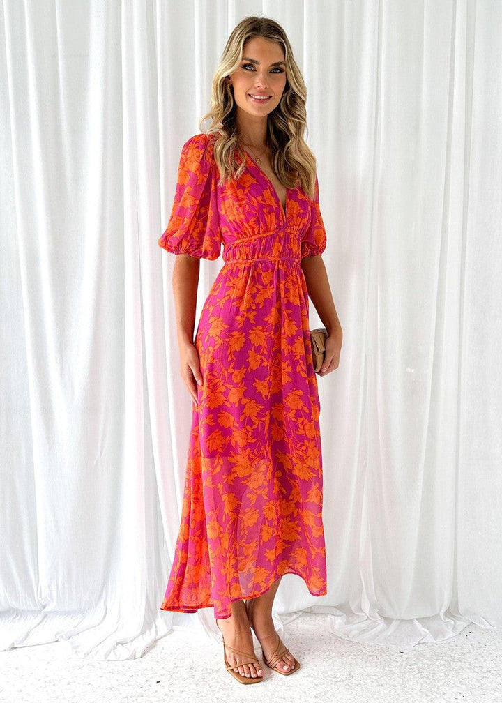 Stylish women's midi wrap dress with floral print & puff sleeves, suitable as an elegant wedding guest or party dress.