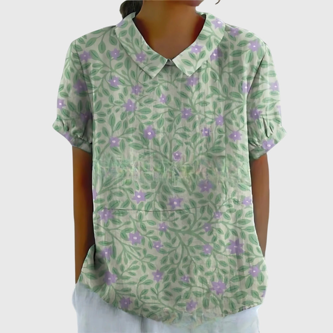 Woman wearing a women's floral print collared blouse, styled casually for a summer day.